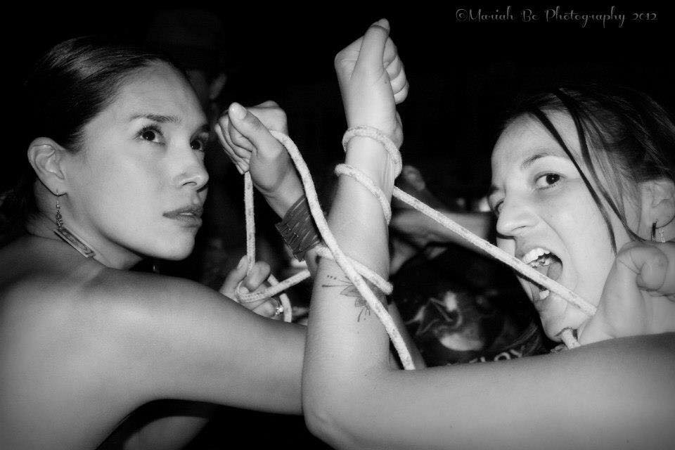 Katrina Kaye and Jessica Helen Lopez - black and white image of two women playing with rope wrapped around arms